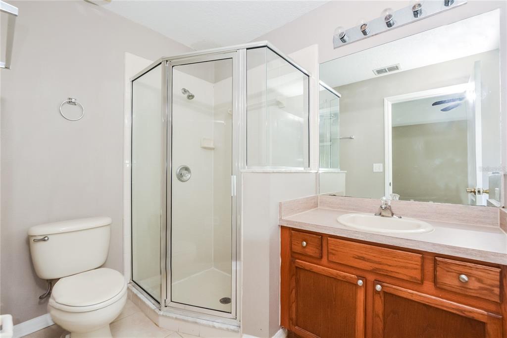 713 Willow Run Street Minneola, FL 34715 - Photo 14 of 16 a bathroom with a sink toilet and shower