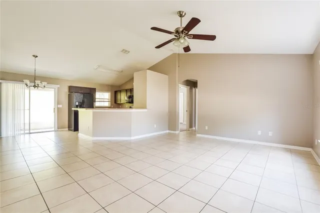 a view of a livingroom with a ceiling fan and window