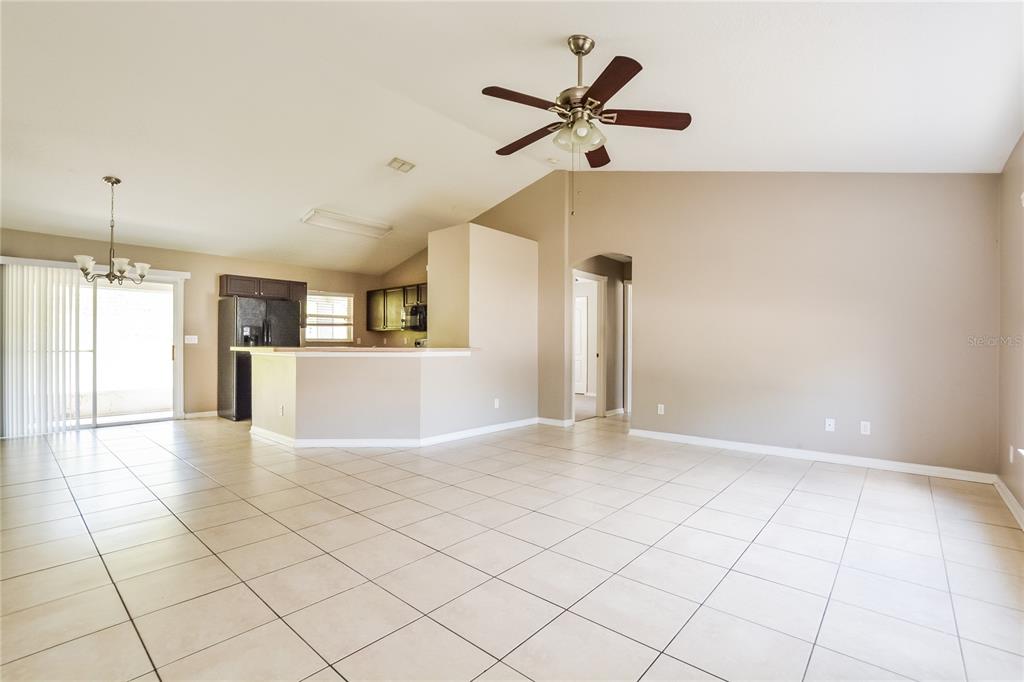 713 Willow Run Street Minneola, FL 34715 - Photo 3 of 16 a view of a livingroom with a ceiling fan and window