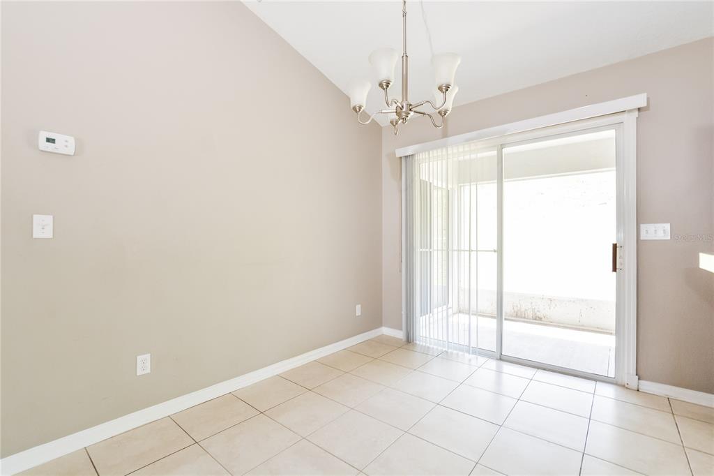 713 Willow Run Street Minneola, FL 34715 - Photo 4 of 16 a view of an empty room with a window