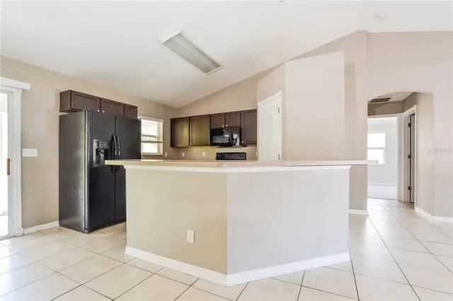 a kitchen with stainless steel appliances a refrigerator sink and microwave