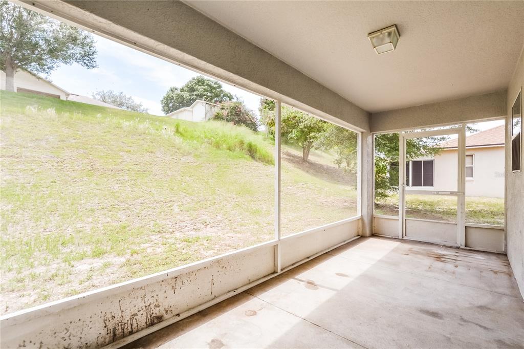 713 Willow Run Street Minneola, FL 34715 - Photo 7 of 16 a view of an empty room and window