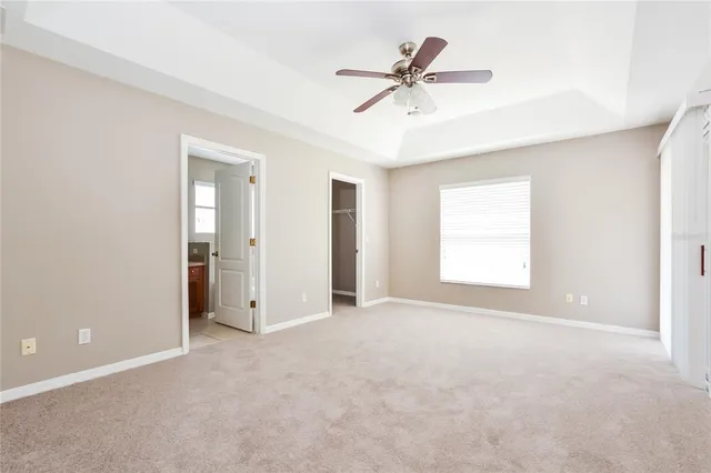a view of a livingroom with a ceiling fan and window