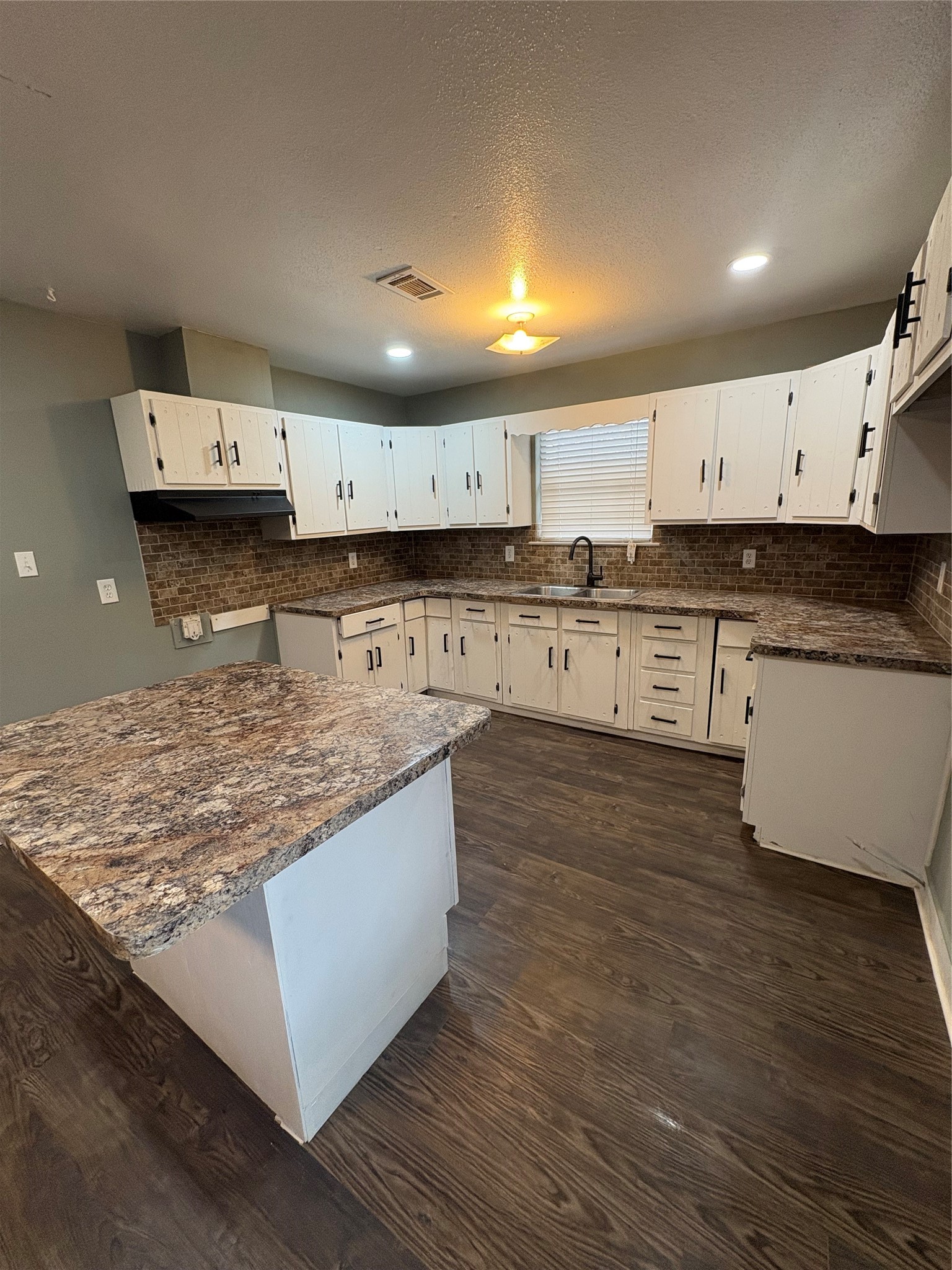 1301 Magnolia Point Drive Huffman, TX 77336 - Photo 3 of 12 a kitchen with stainless steel appliances granite countertop a stove a sink and a refrigerator