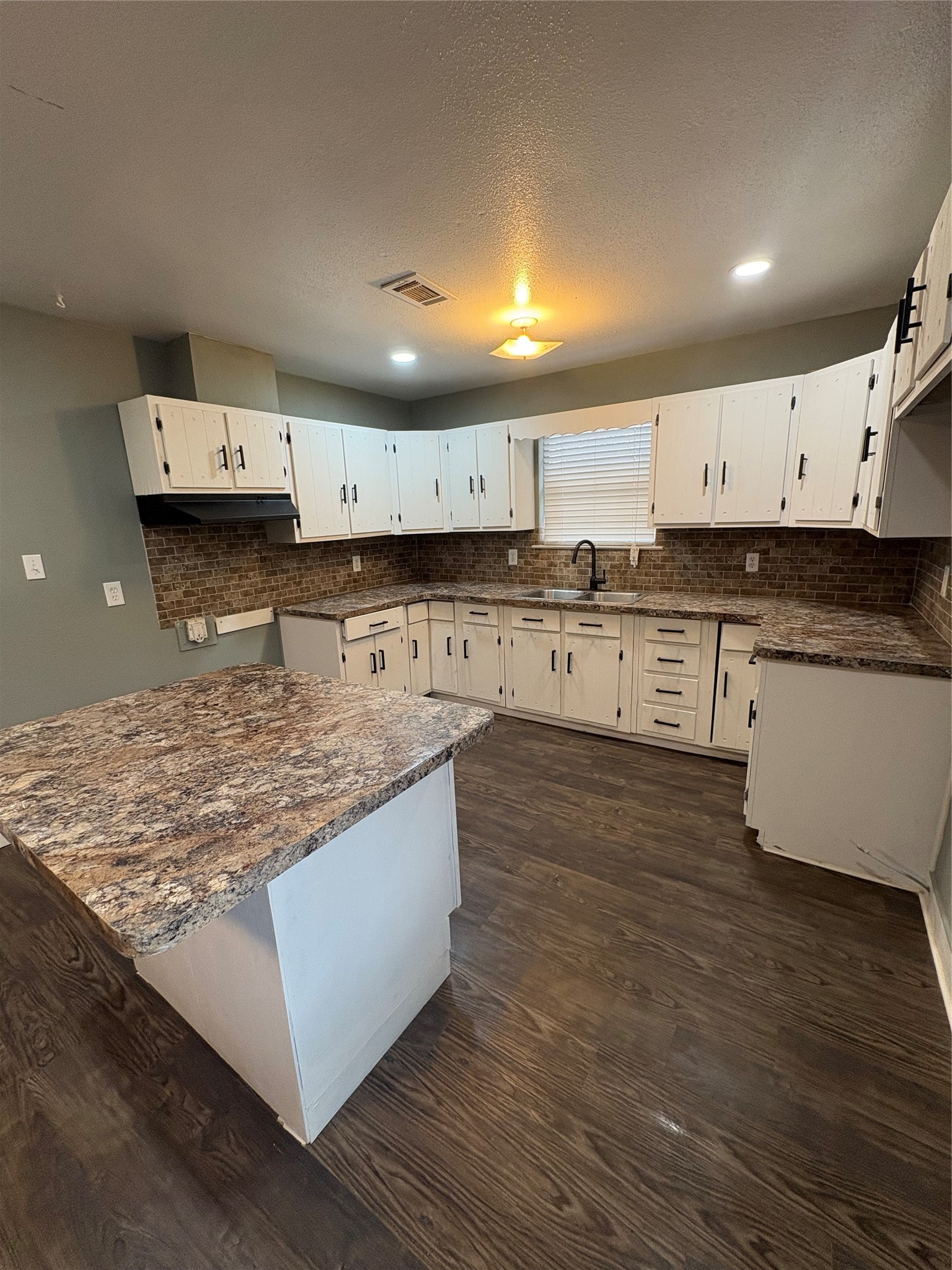 1301 Magnolia Point Drive Huffman, TX 77336 - Photo 4 of 12 a kitchen with stainless steel appliances granite countertop a stove a sink and a refrigerator