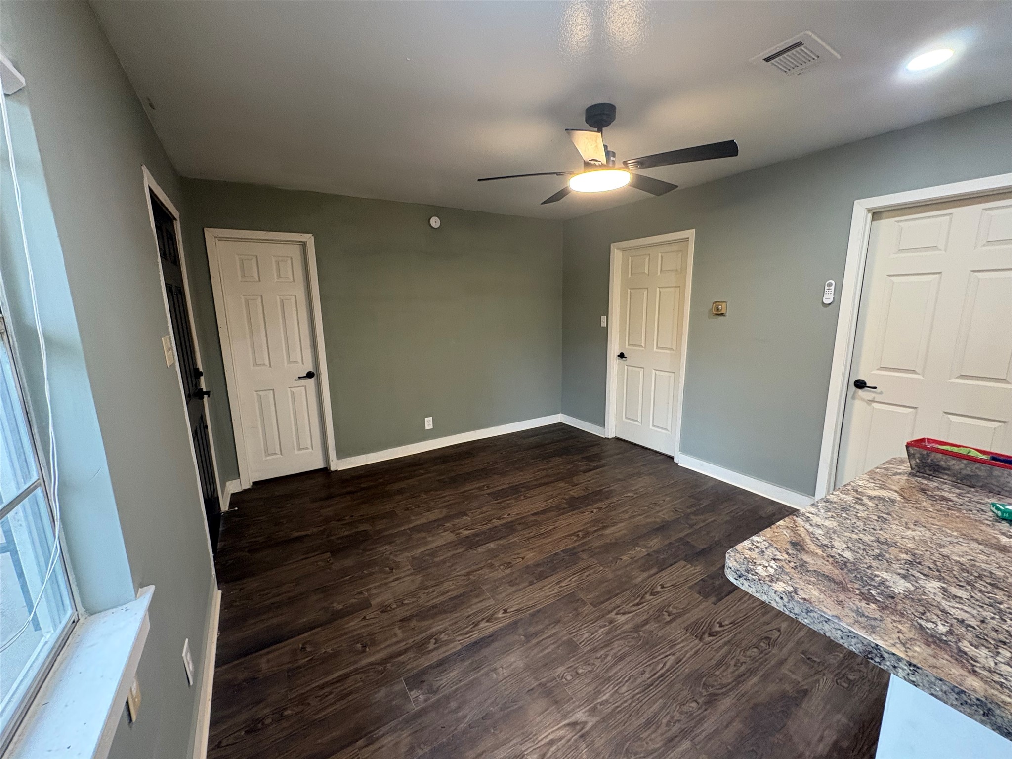 1301 Magnolia Point Drive Huffman, TX 77336 - Photo 7 of 12 a view of a bedroom with wooden floor and ceiling fan