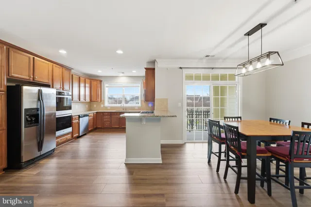 a large kitchen with a table and chairs