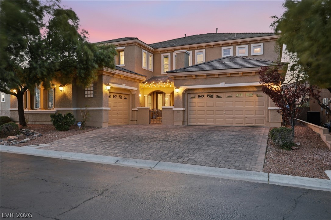 2737 Tarbert Street Henderson, NV 89044 - Photo 11 of 60 This grand residence showcases a classic exterior with an inviting entrance and ample parking.