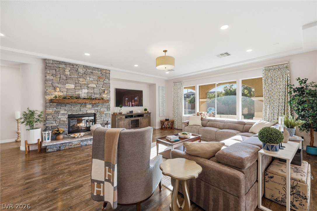 2737 Tarbert Street Henderson, NV 89044 - Photo 17 of 60 This inviting living room boasts a charming stone fireplace and beautiful hardwood flooring.
