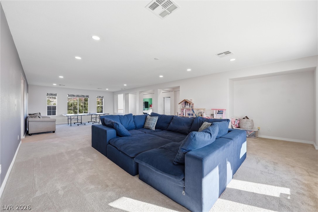 2737 Tarbert Street Henderson, NV 89044 - Photo 26 of 60 This expansive recreation room offers ample space for various activities and relaxation.