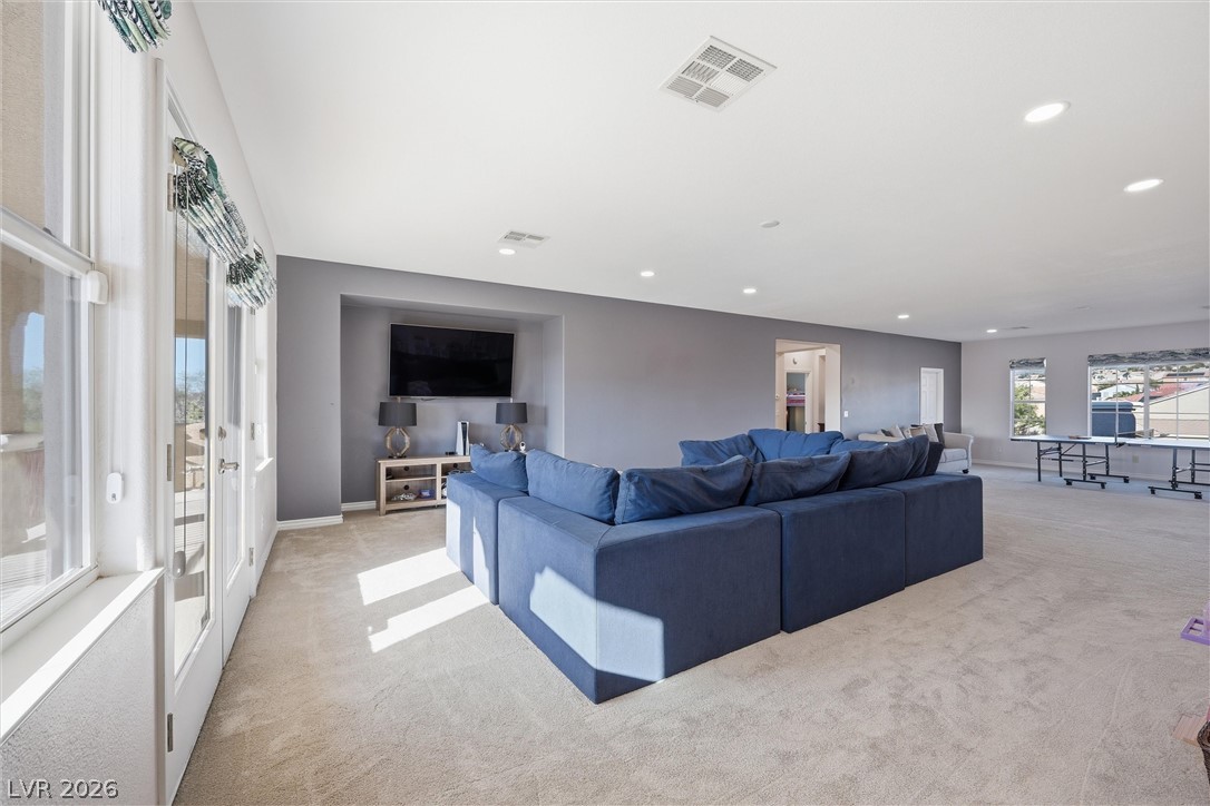 2737 Tarbert Street Henderson, NV 89044 - Photo 27 of 60 This versatile living area features plush carpeting and abundant natural light through multiple windows.