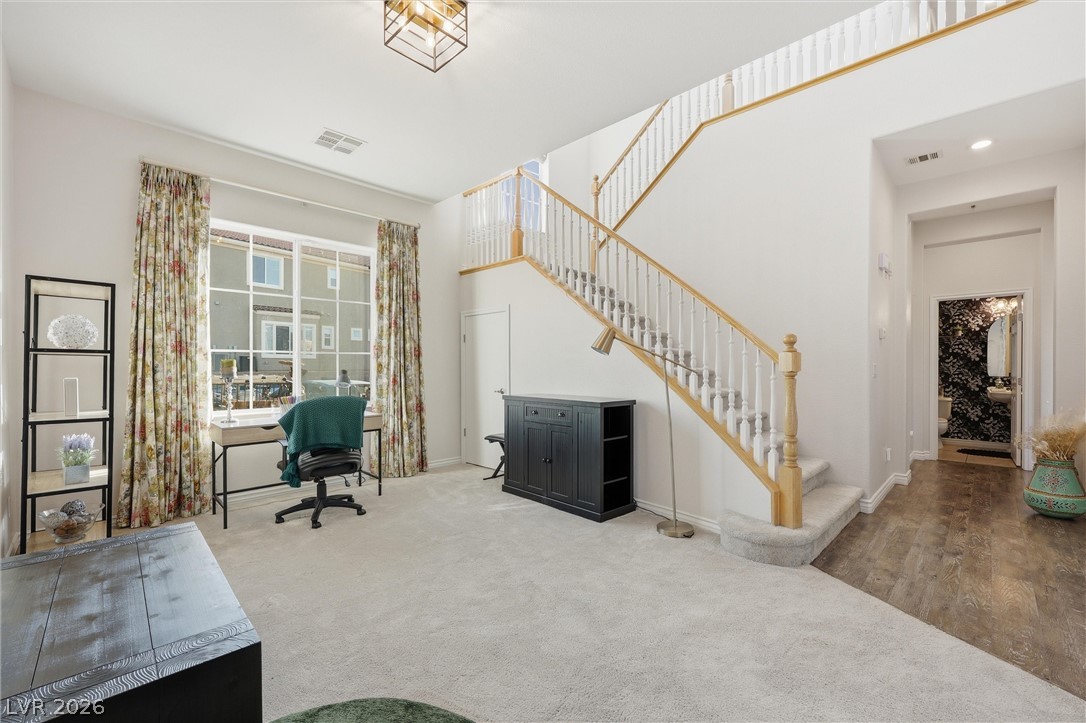 2737 Tarbert Street Henderson, NV 89044 - Photo 29 of 60 This bright and airy interior features a grand staircase and ample natural light, creating an inviting atmosphere.