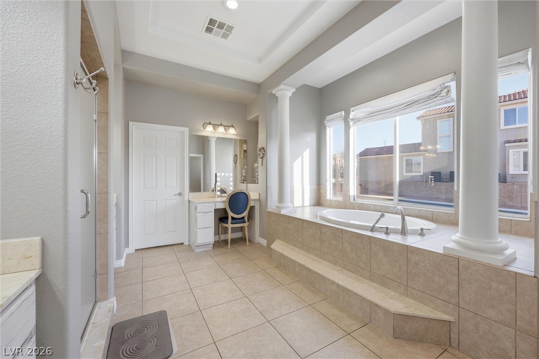 2737 Tarbert Street Henderson, NV 89044 - Photo 32 of 60 This spacious bathroom offers a serene retreat with a built-in tub and ample natural light.