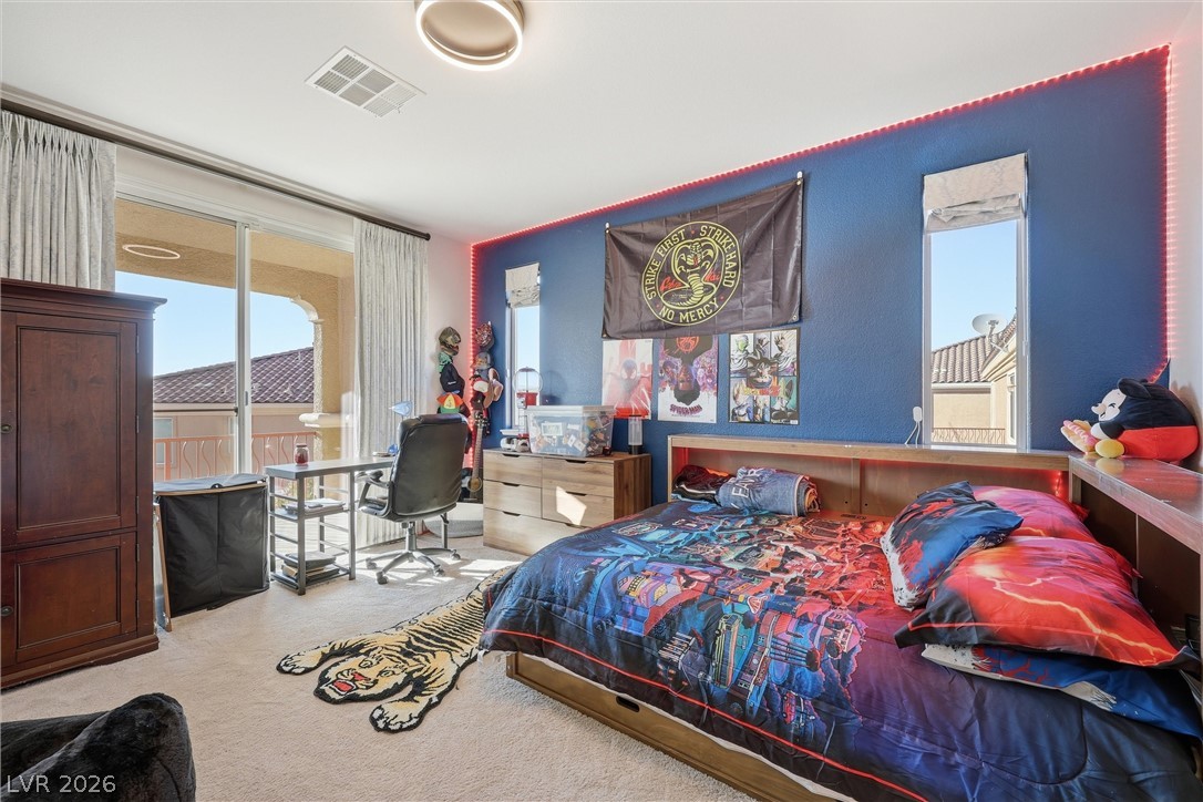 2737 Tarbert Street Henderson, NV 89044 - Photo 34 of 60 This spacious bedroom offers comfortable living with a private balcony, perfect for relaxation.