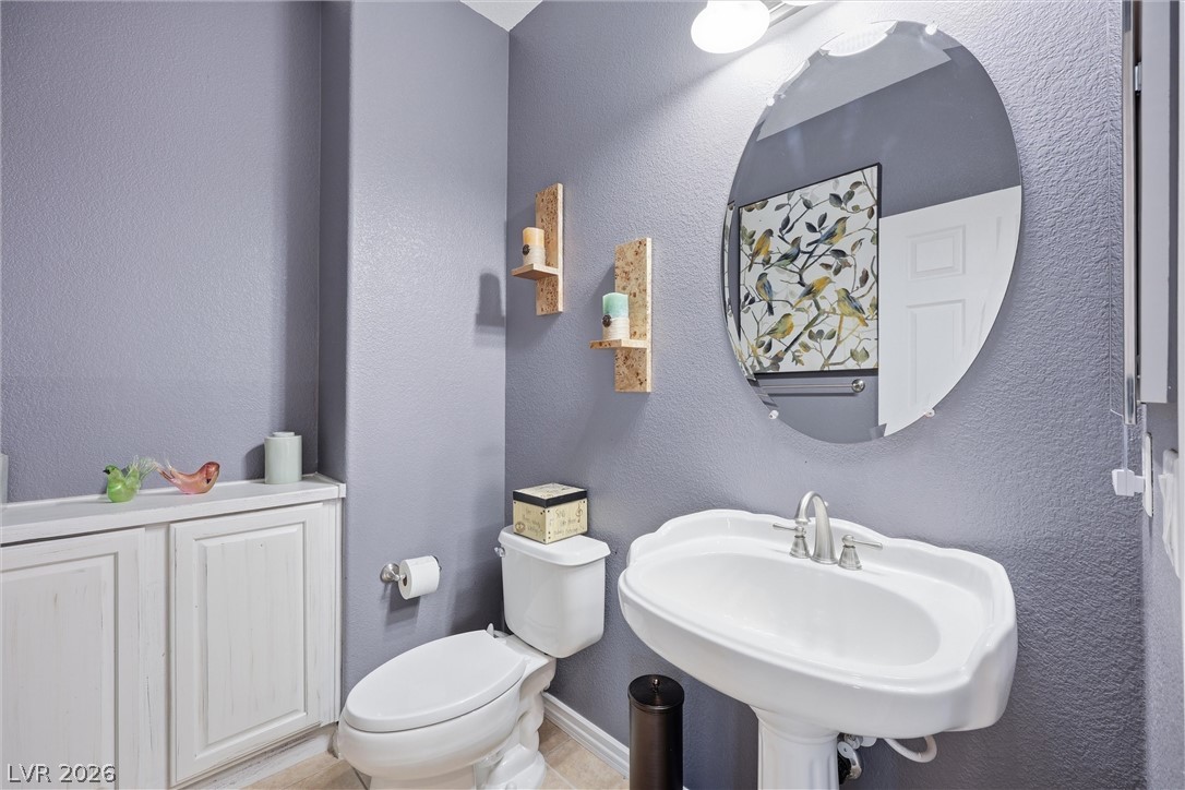 2737 Tarbert Street Henderson, NV 89044 - Photo 41 of 60 This bright bathroom features a pedestal sink and convenient built-in storage.
