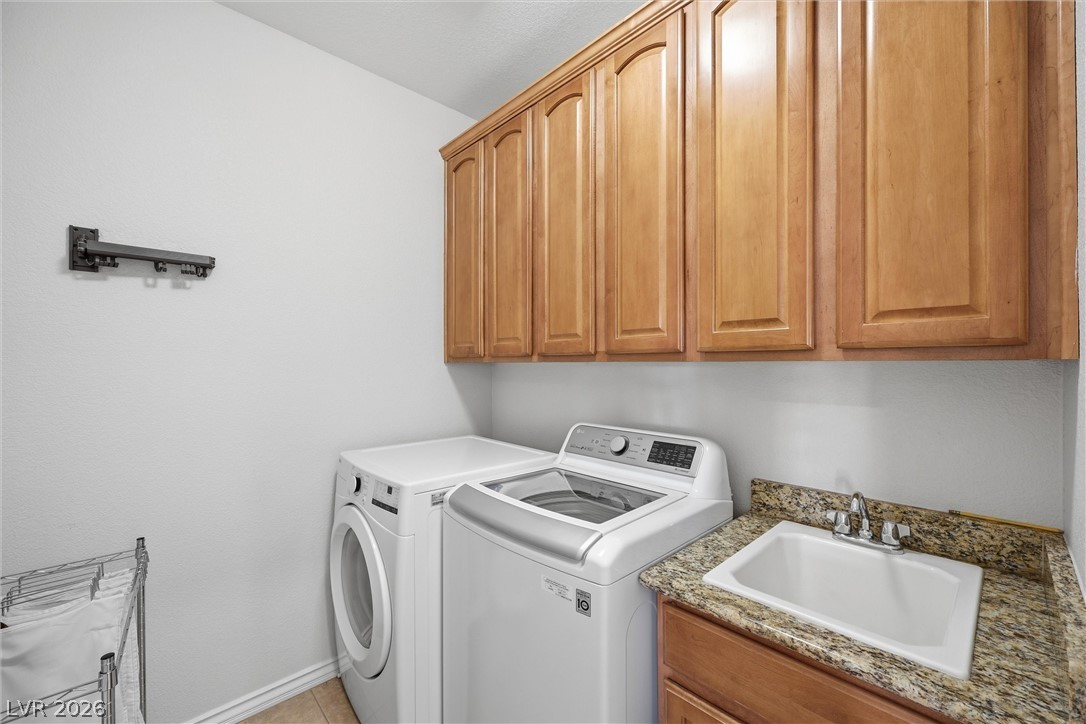 2737 Tarbert Street Henderson, NV 89044 - Photo 43 of 60 This dedicated laundry room features functional appliances and ample storage for household needs.