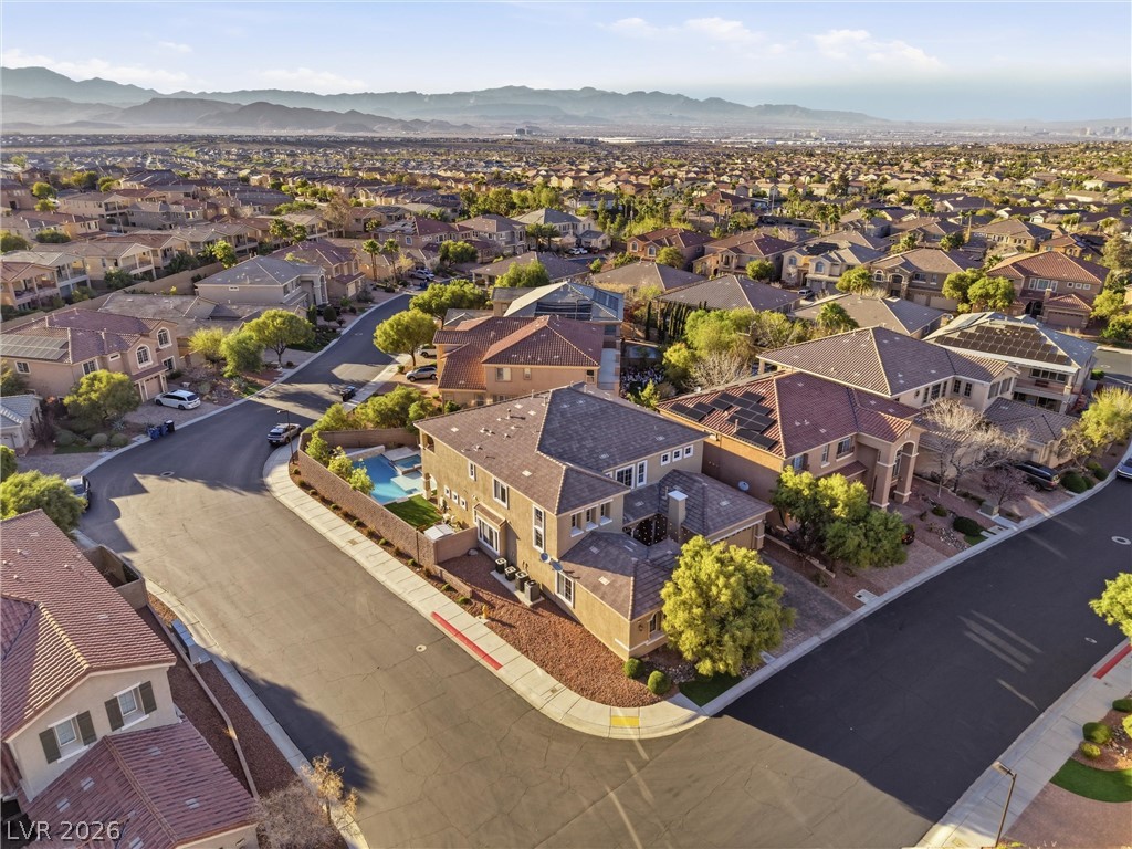 2737 Tarbert Street Henderson, NV 89044 - Photo 48 of 60 An aerial view showcases a vibrant community with diverse architecture against a mountain backdrop.