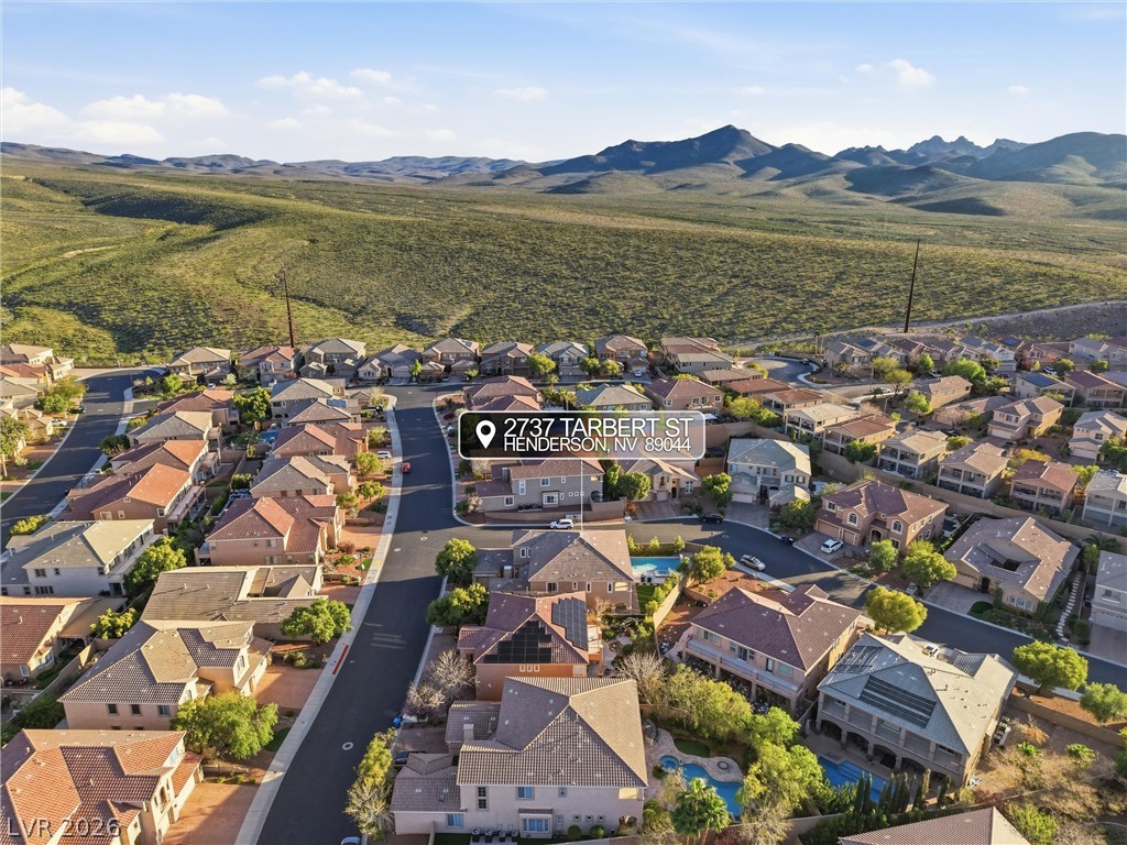 2737 Tarbert Street Henderson, NV 89044 - Photo 49 of 60 An aerial perspective reveals a vibrant neighborhood nestled against picturesque desert mountains.