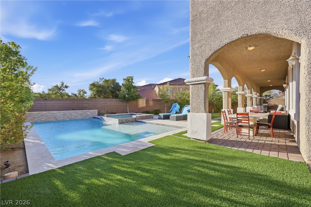 2737 Tarbert Street Henderson, NV 89044 - Photo 5 of 60 An inviting backyard oasis features a pool and spa, perfect for outdoor relaxation and entertainment.