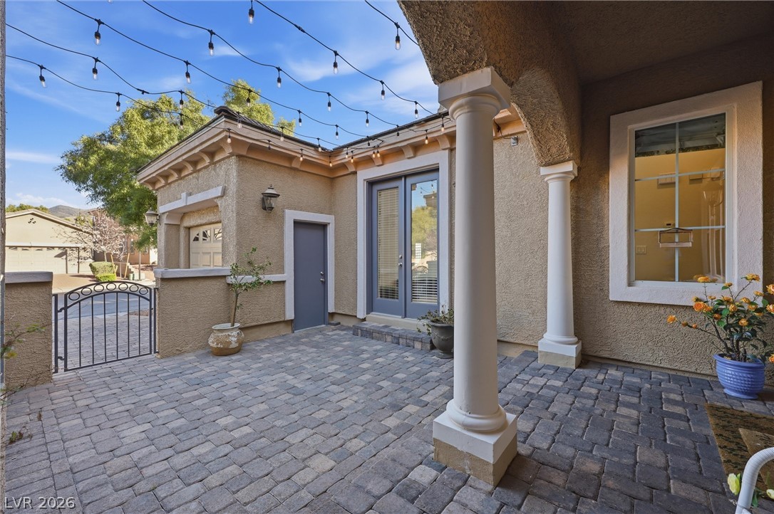 2737 Tarbert Street Henderson, NV 89044 - Photo 51 of 60 This inviting patio area features elegant columns and string lights, perfect for relaxed outdoor living.