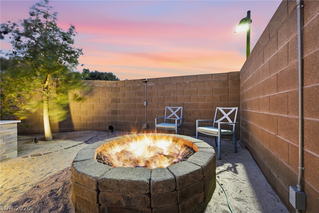 2737 Tarbert Street Henderson, NV 89044 - Photo 52 of 60 This private yard features a captivating fire pit, perfect for evening gatherings under colorful skies.