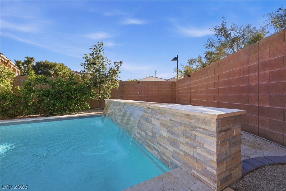 2737 Tarbert Street Henderson, NV 89044 - Photo 57 of 60 This outdoor oasis features a tranquil pool with a captivating waterfall feature.