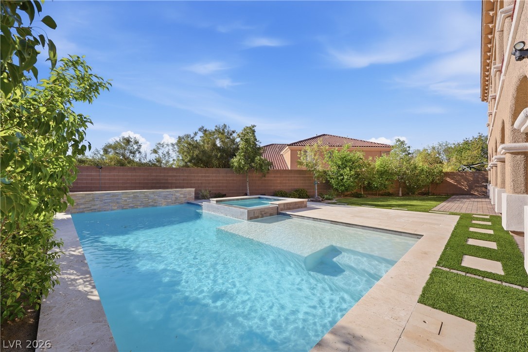 2737 Tarbert Street Henderson, NV 89044 - Photo 58 of 60 This spacious backyard oasis features a sparkling pool and spa, perfect for outdoor enjoyment.