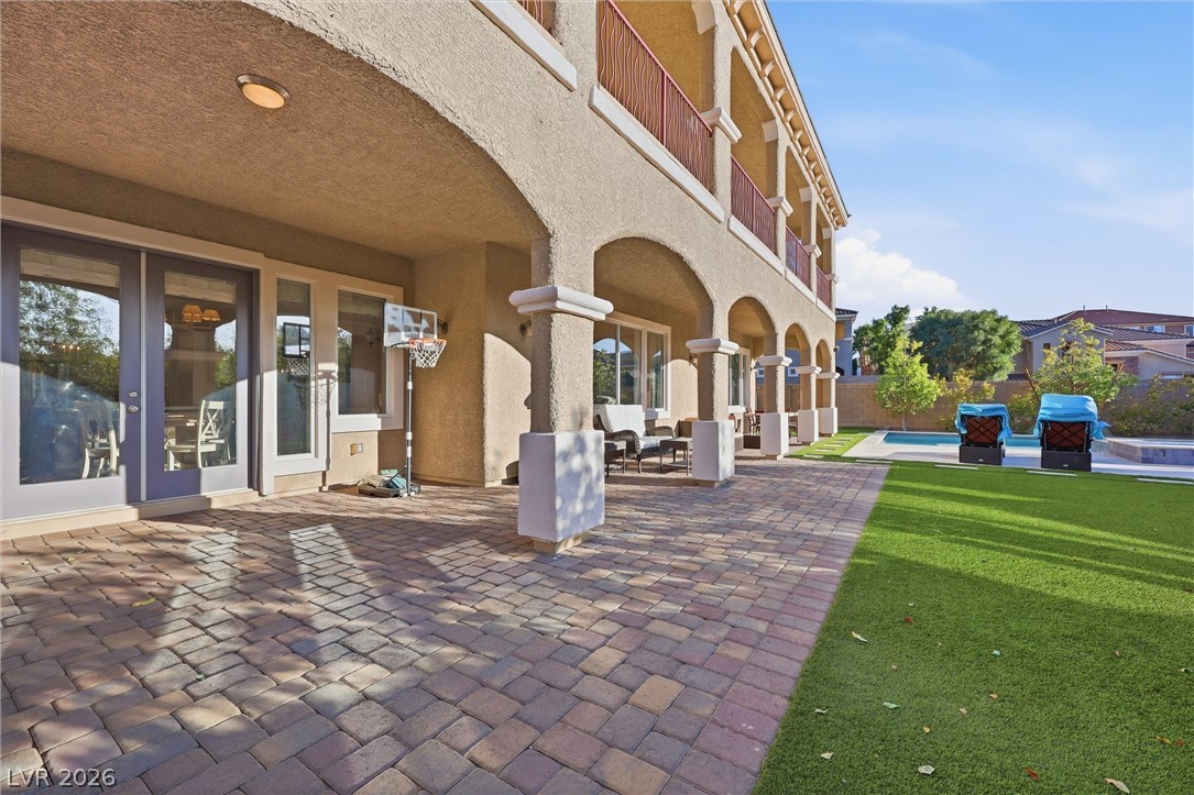 2737 Tarbert Street Henderson, NV 89044 - Photo 7 of 60 This outdoor space features a paver patio and green lawn, perfect for relaxation and entertainment.