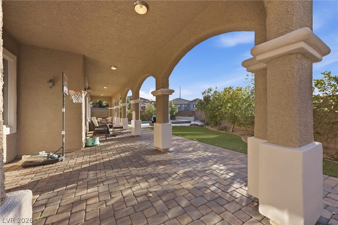 2737 Tarbert Street Henderson, NV 89044 - Photo 8 of 60 An inviting covered patio featuring paver flooring and views of the backyard.