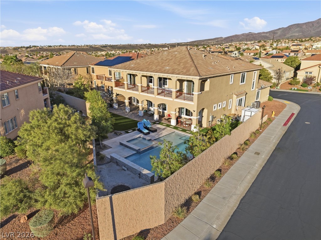 2737 Tarbert Street Henderson, NV 89044 - Photo 9 of 60 This residence features a tiled roof and stucco exterior, complemented by a private pool and spa.