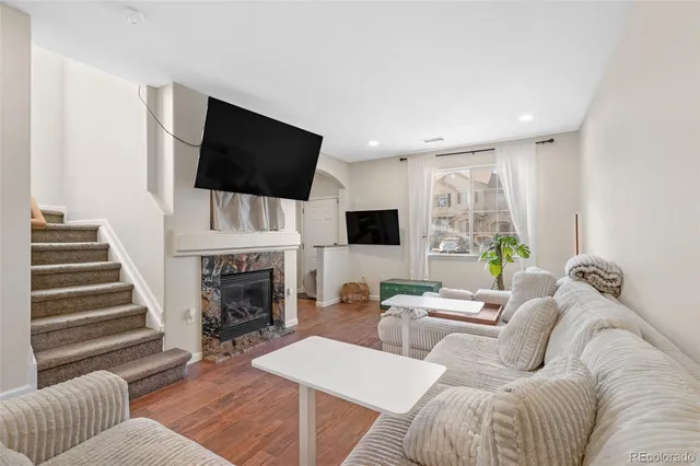 a living room with furniture fireplace and flat screen tv