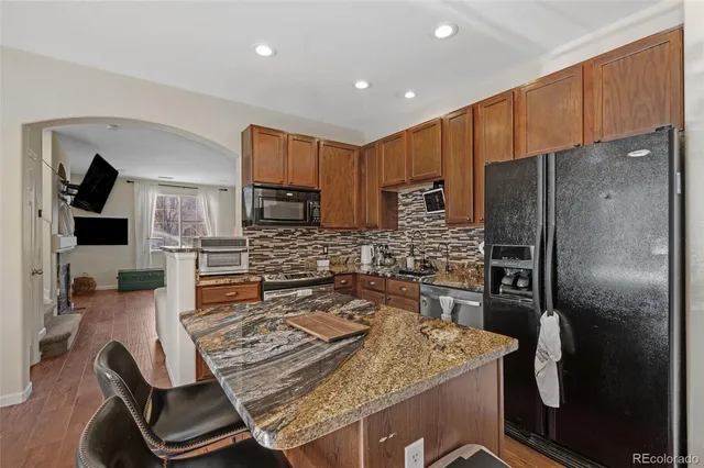 a kitchen with kitchen island a counter top space appliances and cabinets