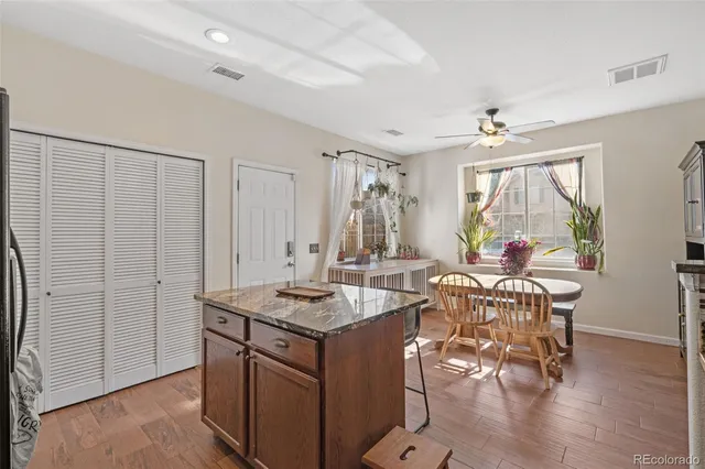 a dinning area with chandelier and wooden floor