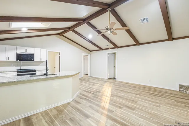 a view of a kitchen with microwave and cabinets