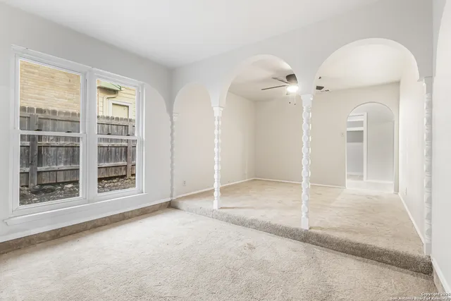 an empty room with a empty space and windows