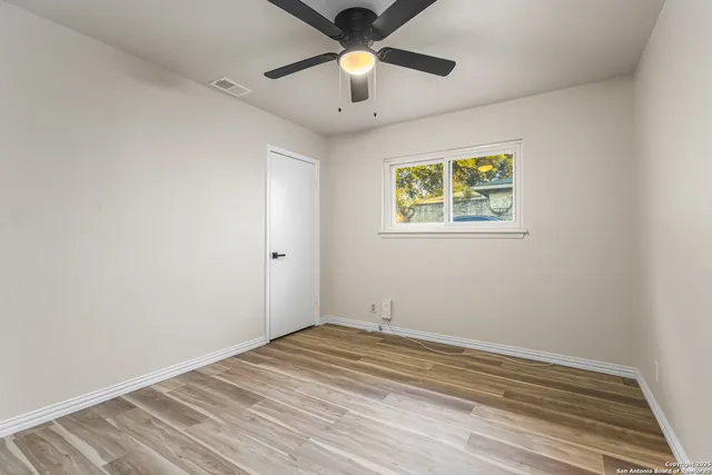a view of room with window and ceiling fan