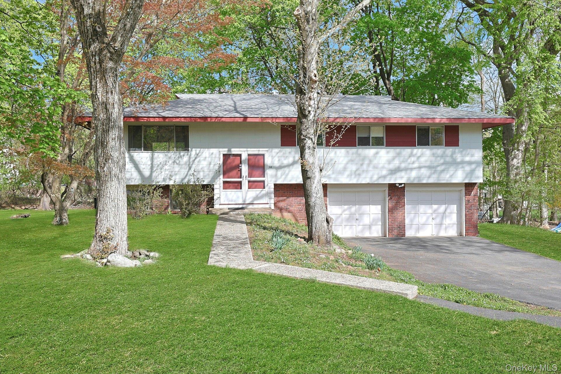 44 Southgate Drive Spring Valley, NY 10977 - Photo 2 of 24 a front view of a house with a yard and garage