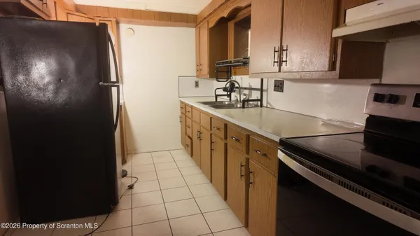 a kitchen with stainless steel appliances a sink stove and cabinets