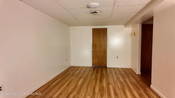 a view of a room with wooden floor