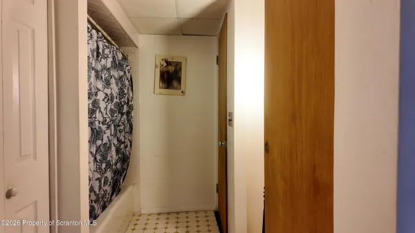 a view of a hallway to a door