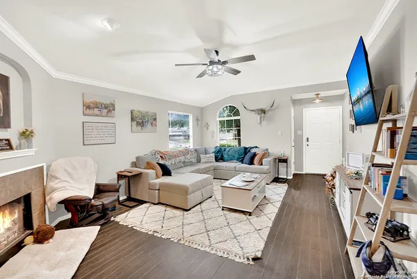 a living room with furniture and a wooden floor