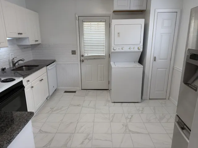 a room with a washing machine and a sink
