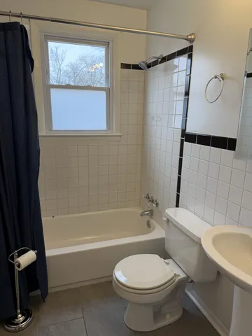 a bathroom with a toilet and a bathtub