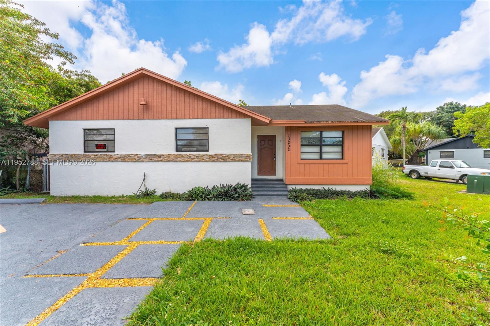 13202 Southwest 276th Terrace Homestead, FL 33032 - Photo 1 of 19 a front view of house with yard and green space
