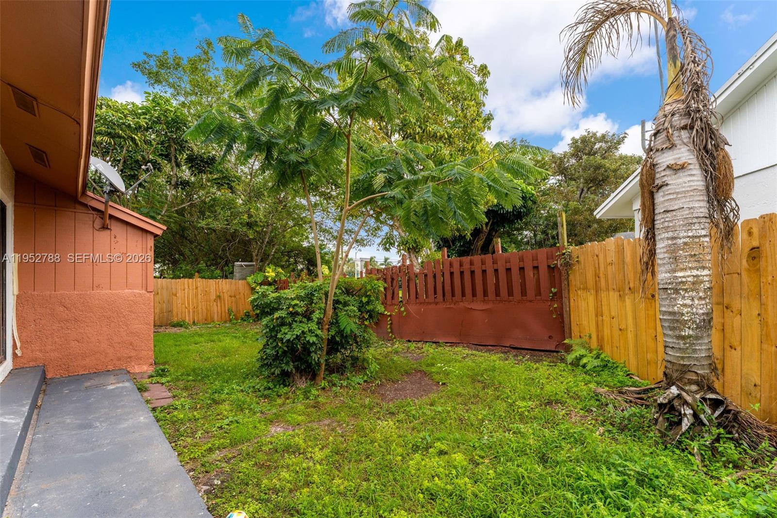 13202 Southwest 276th Terrace Homestead, FL 33032 - Photo 15 of 19 a view of a backyard with potted plants and large tree