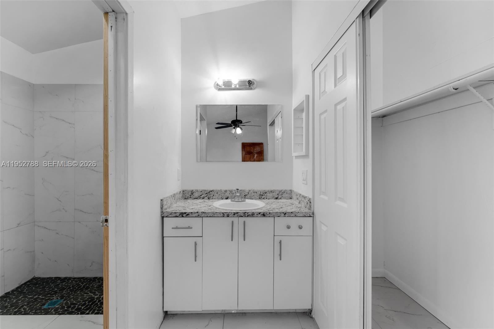 13202 Southwest 276th Terrace Homestead, FL 33032 - Photo 8 of 19 a bathroom with a granite countertop sink and a mirror