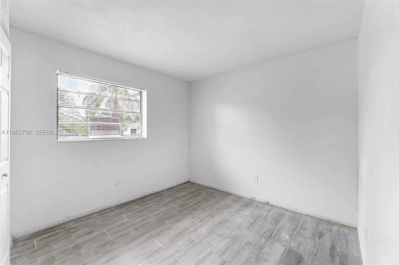 13202 Southwest 276th Terrace Homestead, FL 33032 - Photo 10 of 19 an empty room with a window