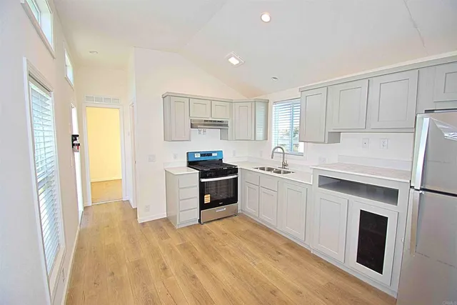 a kitchen with a sink a stove and a refrigerator