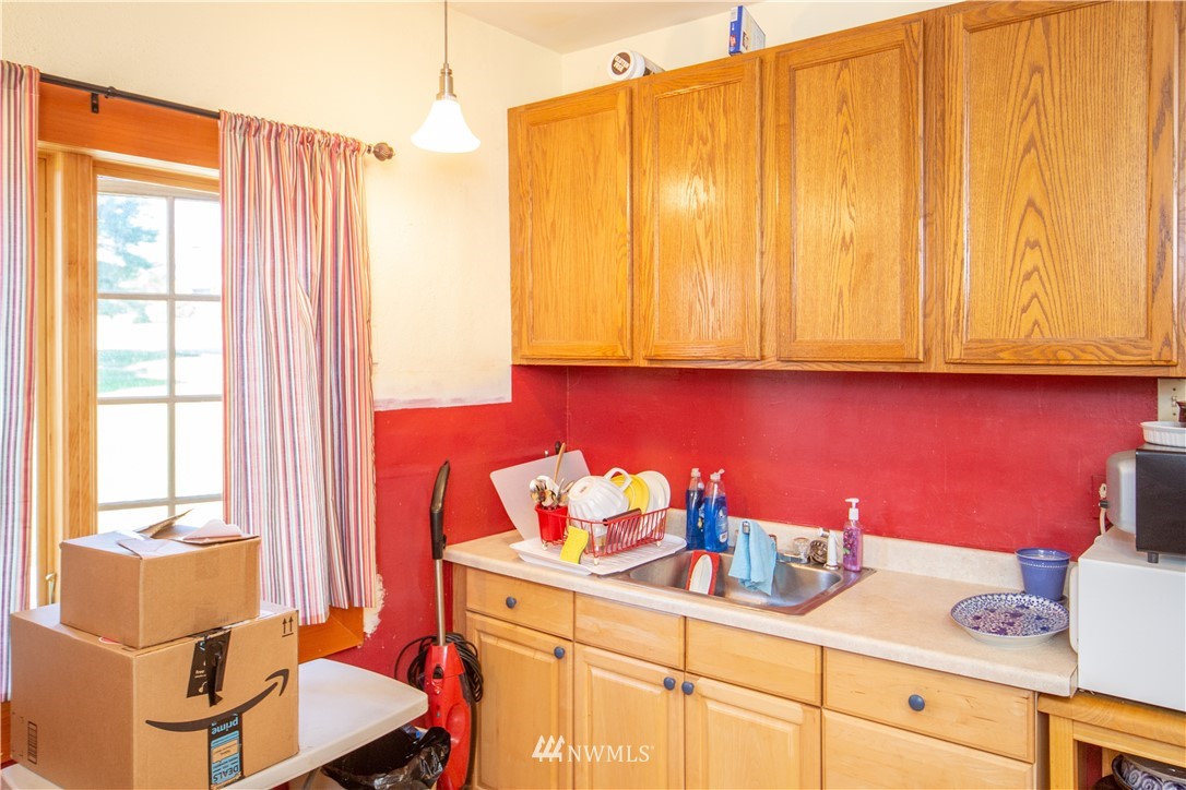 717 Franklin Street Port Townsend, WA 98368 - Photo 12 of 25 a kitchen with a sink cabinets and window