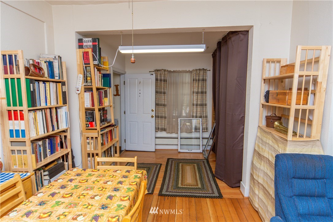 717 Franklin Street Port Townsend, WA 98368 - Photo 3 of 25 a living room with lots of furniture and a book shelf